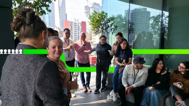 Networking corporativo durante un desayuno empresarial en una terraza con vista urbana, donde profesionales conversan y construyen relaciones de negocio.